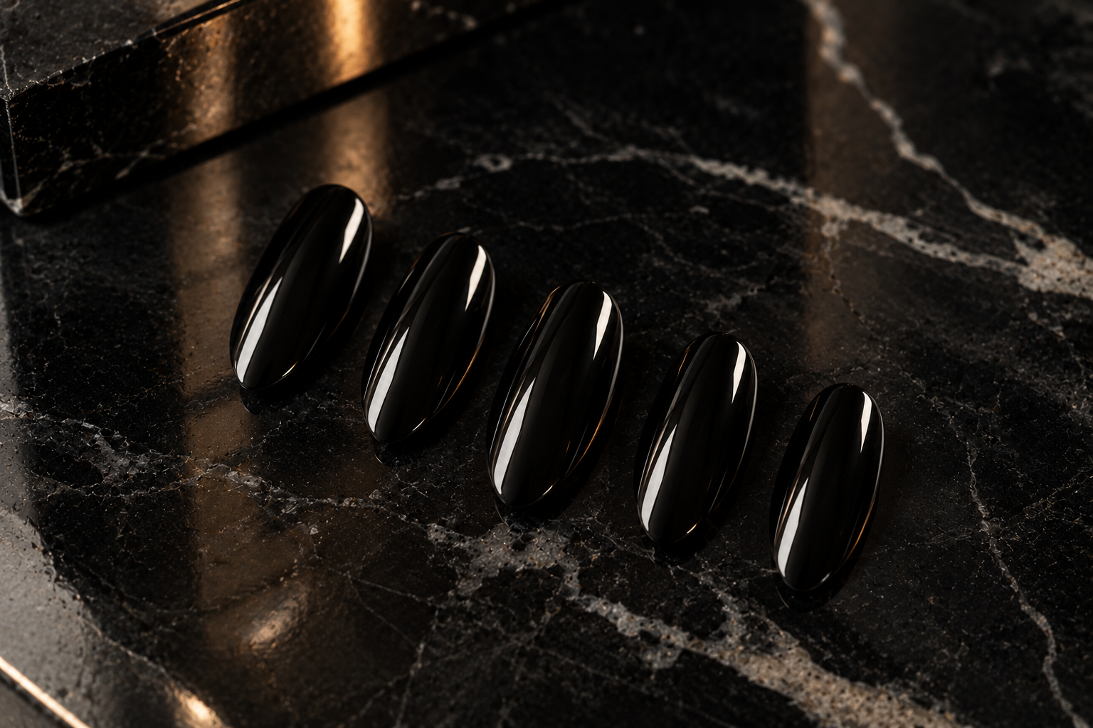 SET. 004 NOIR glossy black almond press-on nails photographed on polished black marble.