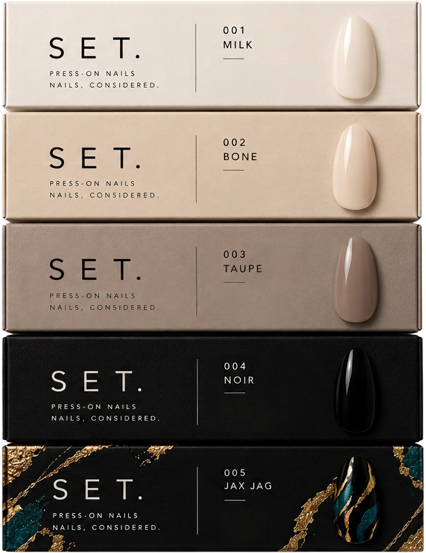 SET. packaging, stacked in Core shade order: 001 MILK, 002 BONE, 003 TAUPE, 004 NOIR and 005 JAX JAG.